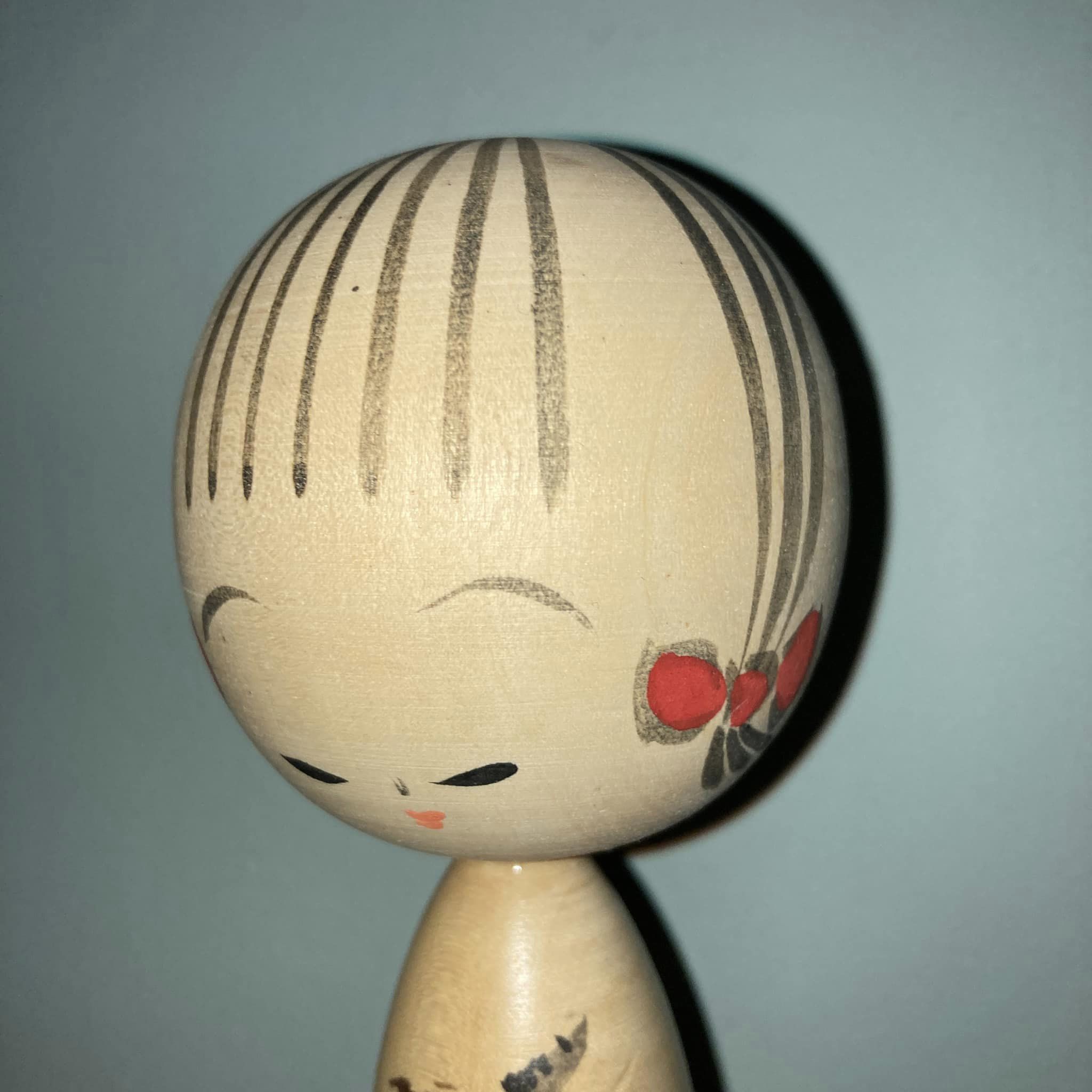 Kokeshi with maple leaves by Watanabe Masao